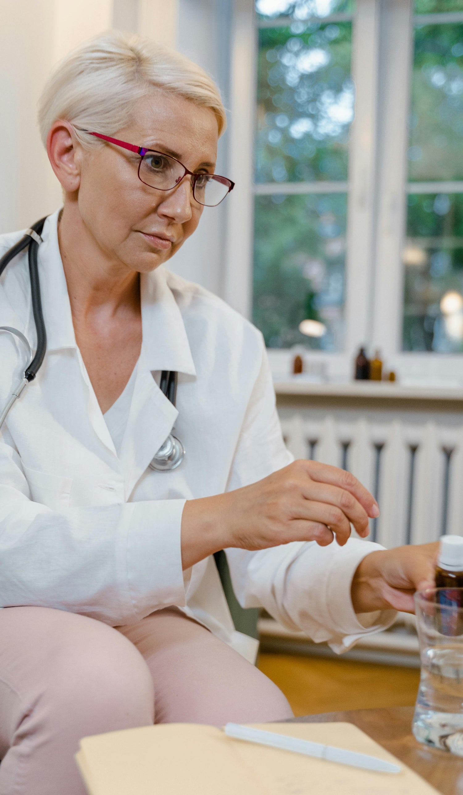 Doctor in a white coat sitting at a desk with a nicotine vape prescription.