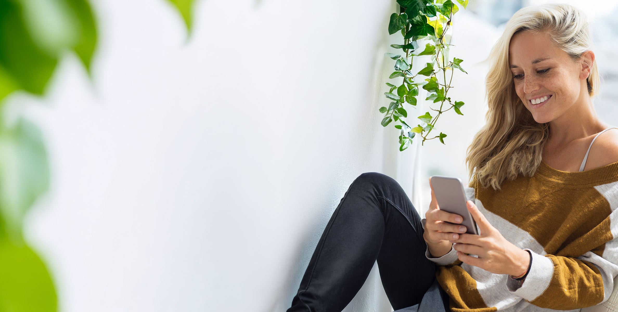 A smiling blonde woman applying for a nicotine vape prescription online from a quit smoking clinic.