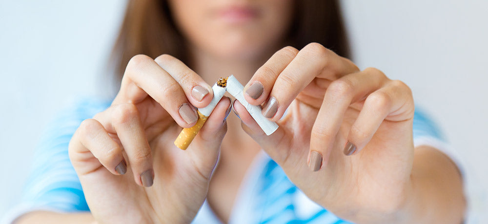 Person breaking a cigarette with a blurred background