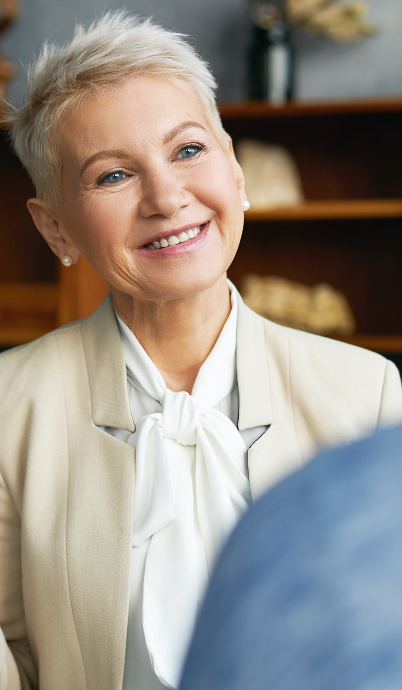 Quit smoking doctor with short blonde hair smiling in an office setting