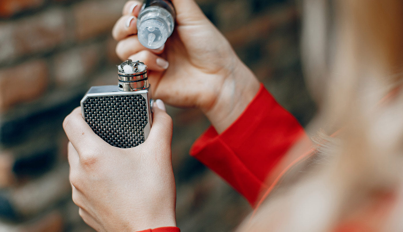 Person holding a vape with a blurred background